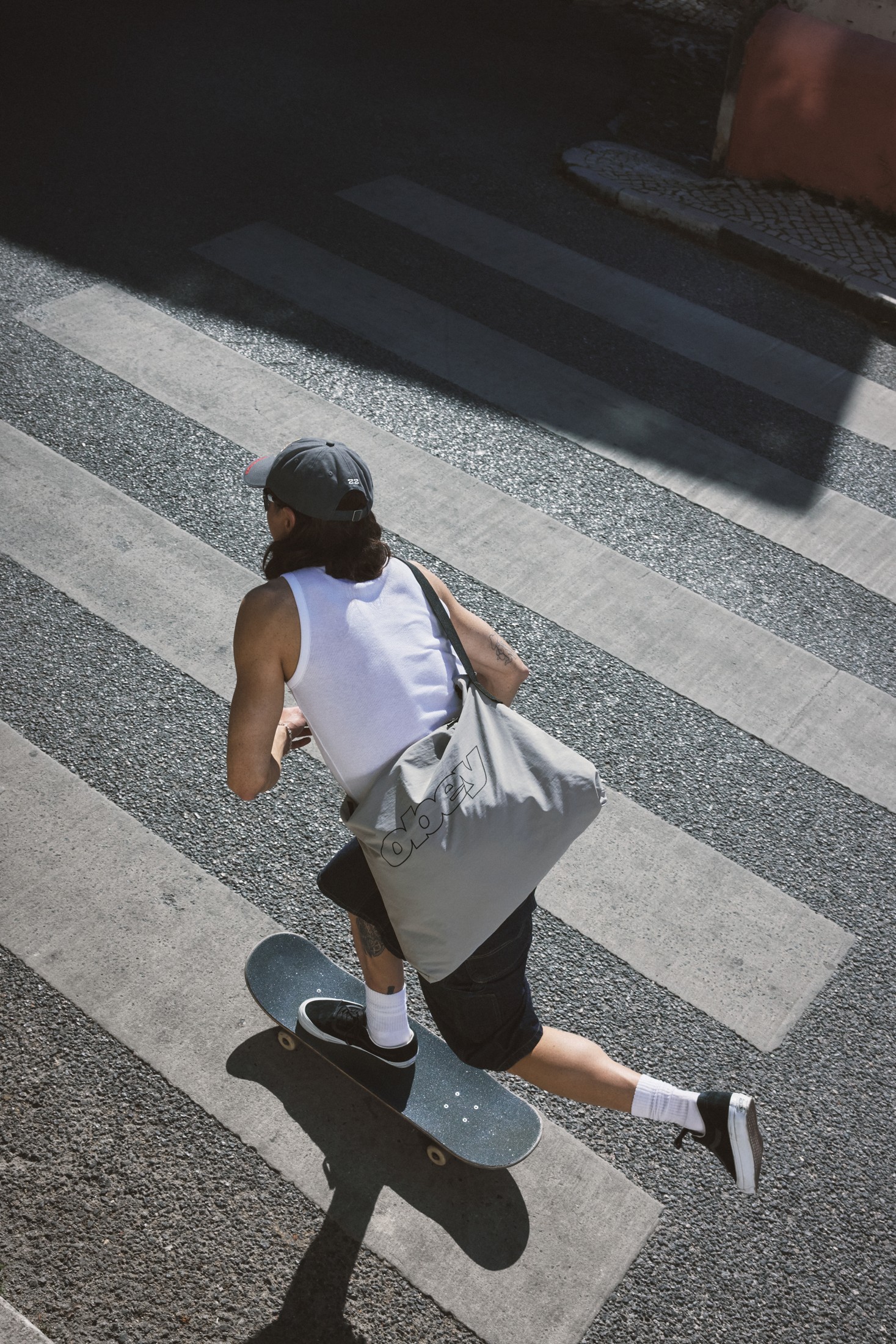 A skateboarder crossing a Lisbon street